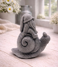 Load image into Gallery viewer, A handmade vegan soap gift, sculpted as a whimsical gnome (gonk) with a tall, slouchy hat and a long beard, sitting on the shell of a large snail with a textured, bumpy body.
