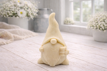 Load image into Gallery viewer, A cream-coloured handmade vegan soap sculpted as a tall, whimsical gnome (gonk) with a pointed hat and long beard, featuring a natural twine hanging rope at the top and displayed in a bright farmhouse setting.
