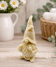 Load image into Gallery viewer, A handmade vegan soap in the shape of a gnome with a long beard, wearing a honeycomb-patterned hat with a bee, holding a honey pot and dipper.
