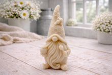 Load image into Gallery viewer, A handmade vegan soap in the shape of a gnome with a long beard, wearing a honeycomb-patterned hat with a bee, holding a honey pot and dipper.
