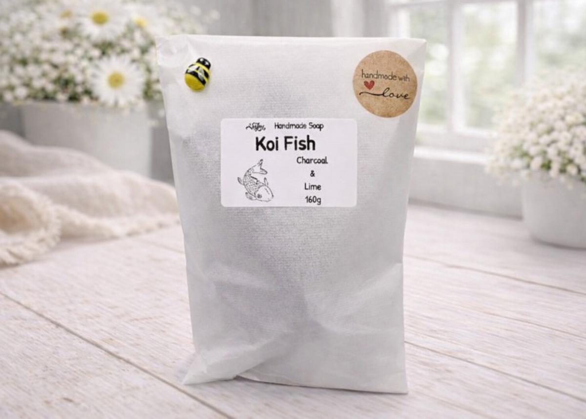 White bag of 'Koi Fish' soap with a label on a wooden surface