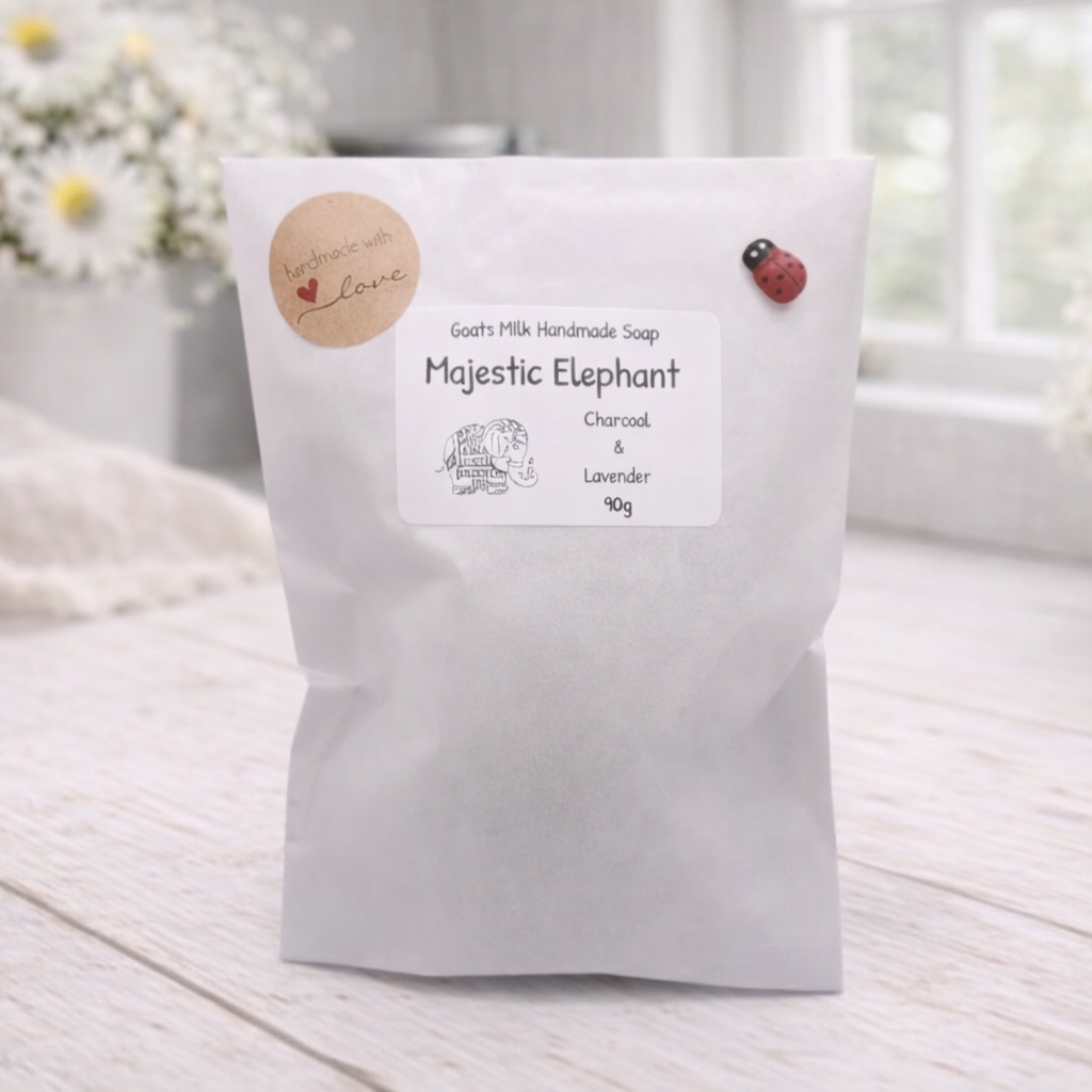 White product packaging with a label on a light wooden surface, surrounded by decorative elements.