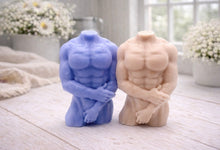 Load image into Gallery viewer, A 3D handmade vegan soap sculpted into a detailed male torso with defined chest and abdominal muscles, finished in a soft tone and displayed in a bright farmhouse setting.
