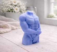Load image into Gallery viewer, A 3D handmade vegan soap sculpted into a detailed male torso with defined chest and abdominal muscles, finished in a soft tone and displayed in a bright farmhouse setting.
