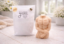 Load image into Gallery viewer, A 3D handmade vegan soap sculpted into a detailed male torso with defined chest and abdominal muscles, finished in a soft tone and displayed in a bright farmhouse setting.
