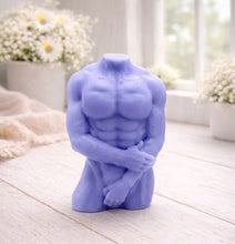 Load image into Gallery viewer, A 3D handmade vegan soap sculpted into a detailed male torso with defined chest and abdominal muscles, finished in a soft tone and displayed in a bright farmhouse setting.
