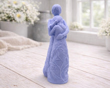 Load image into Gallery viewer, A 3D handmade vegan soap, sculpted as a mother and daughter in a tender standing embrace, featuring an intricate embossed floral and vine pattern on their dresses.
