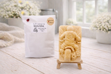 Load image into Gallery viewer, Handmade soap shaped like a motorcycle on a stand with packaging labeled 'Motorbike' in a bright setting.
