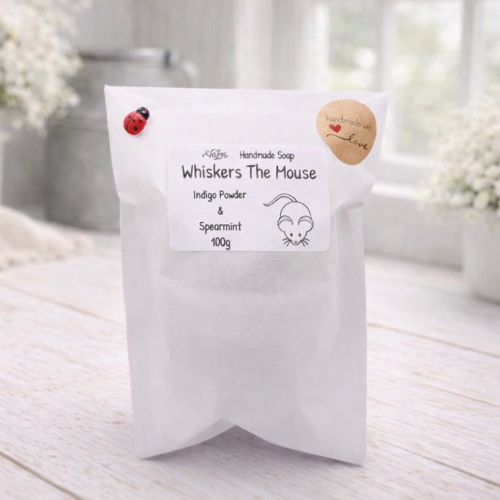 White soap packaging with 'Whiskers The Mouse' branding on a light wooden surface.