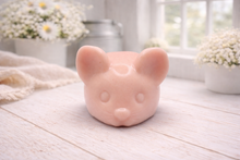 Load image into Gallery viewer, A 3D handmade vegan soap sculpted into the shape of a cute resting mouse with large rounded ears and a delicate snout, displayed on a light wooden surface in a bright farmhouse setting
