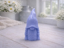 Load image into Gallery viewer, A handmade vegan soap sculpted in the shape of a female gnome (or gonk), featuring a tall, slightly curved hat pulled over the eyes and two thick, textured plaits framing a textured dress, in a natural cream colour.
