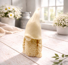 Load image into Gallery viewer, A handmade vegan soap sculpted in the shape of a female gnome (or gonk), featuring a tall, slightly curved hat pulled over the eyes and two thick, textured plaits framing a textured dress, in a natural cream colour.
