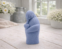 Load image into Gallery viewer, A 3D handmade vegan soap sculpted as a standing penguin tenderly cradling a heart against its chest, displayed on a light wooden surface in a bright farmhouse setting.
