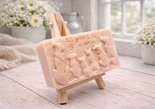 Load image into Gallery viewer, A rectangular handmade vegan soap bar gift, featuring a detailed relief carving of several dogs and a cat sitting together, with the words "all paws matter" and two paw prints embossed at the top, displayed on a wooden easel. Made in Blackpool. 
