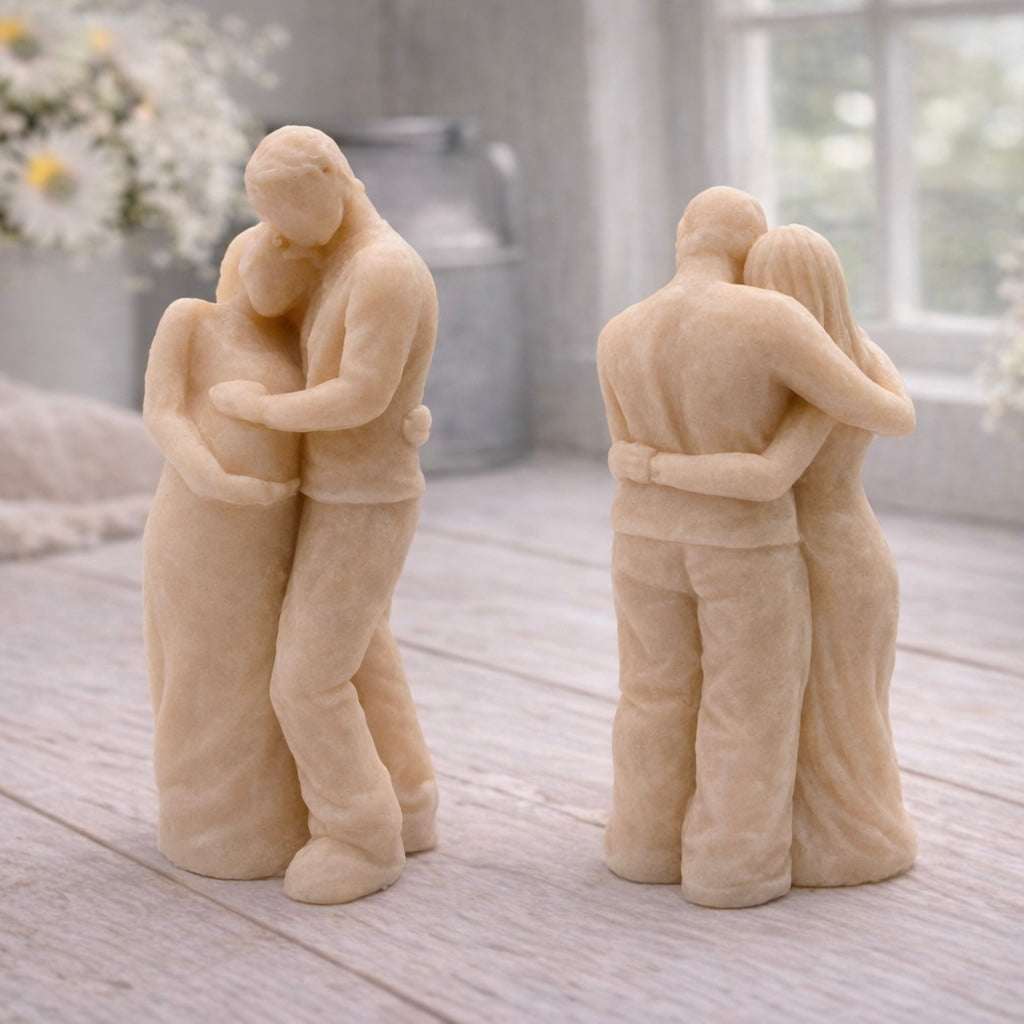 A 3D handmade vegan soap in a warm cream tone, sculpted into a standing figure of a pregnant couple; the partner stands behind the expectant mother, tenderly cradling her baby bump, displayed on a light wooden surface in a bright farmhouse setting.