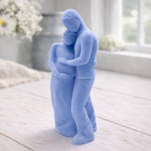 Load image into Gallery viewer, A 3D handmade vegan soap in a warm cream tone, sculpted into a standing figure of a pregnant couple; the partner stands behind the expectant mother, tenderly cradling her baby bump, displayed on a light wooden surface in a bright farmhouse setting.
