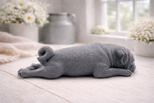 Load image into Gallery viewer, A detailed handmade vegan soap gift, sculpted in the shape of a pug dog lying flat on its stomach in a sleeping position, showing realistic skin folds and fur texture, displayed on a light wooden surface. Handmade in Blackpool 
