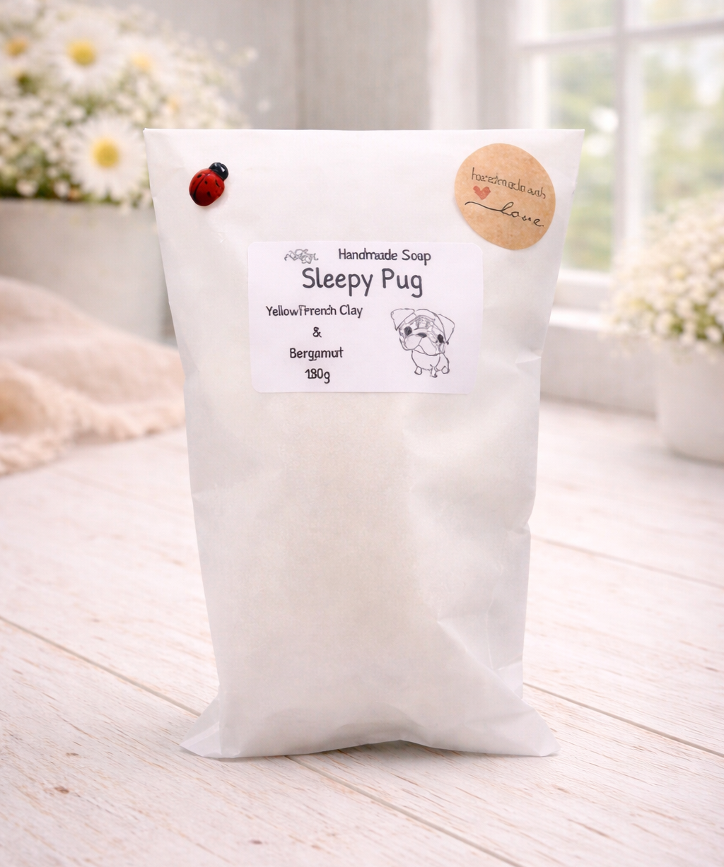 White soap package with 'Sleepy Pug' branding on a wooden surface.
