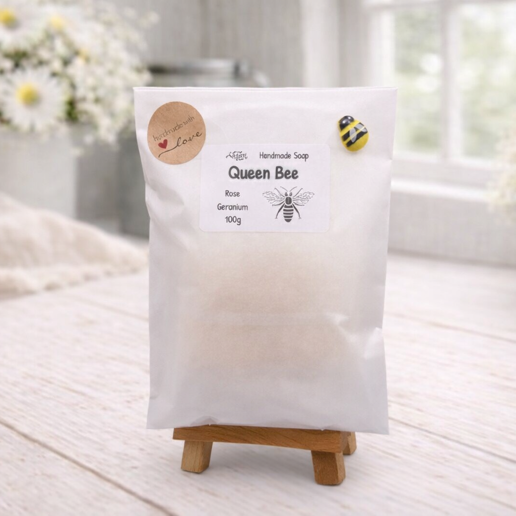 Packaged product labeled 'Queen Bee' on a wooden stand with a light background