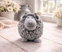 Load image into Gallery viewer, A highly detailed handmade vegan soap sculpted in the shape of a sturdy ram with a thick coat of tight, curly wool and large, elegant curved horns, displayed on a light wooden surface in a bright farmhouse setting.
