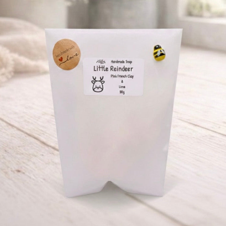 White soap packaging with a label on a light wooden surface