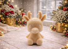 Load image into Gallery viewer, A 3D handmade vegan soap crafted into a cute, sitting baby reindeer with small antlers, rounded features, and a sweet expression, set against a bright farmhouse window.

