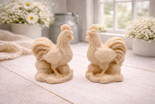Load image into Gallery viewer, Two handmade vegan soaps sculpted in the shape of proud roosters (cockerels) with detailed feathers, combs, and curved tail feathers, standing on a rustic base, in a natural colour. Gift boxed 
