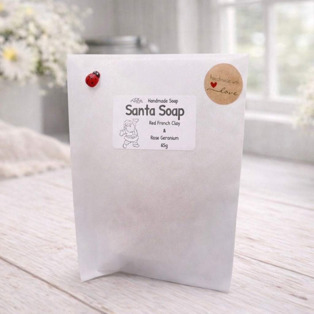 White soap packaging with branding on a light wooden surface