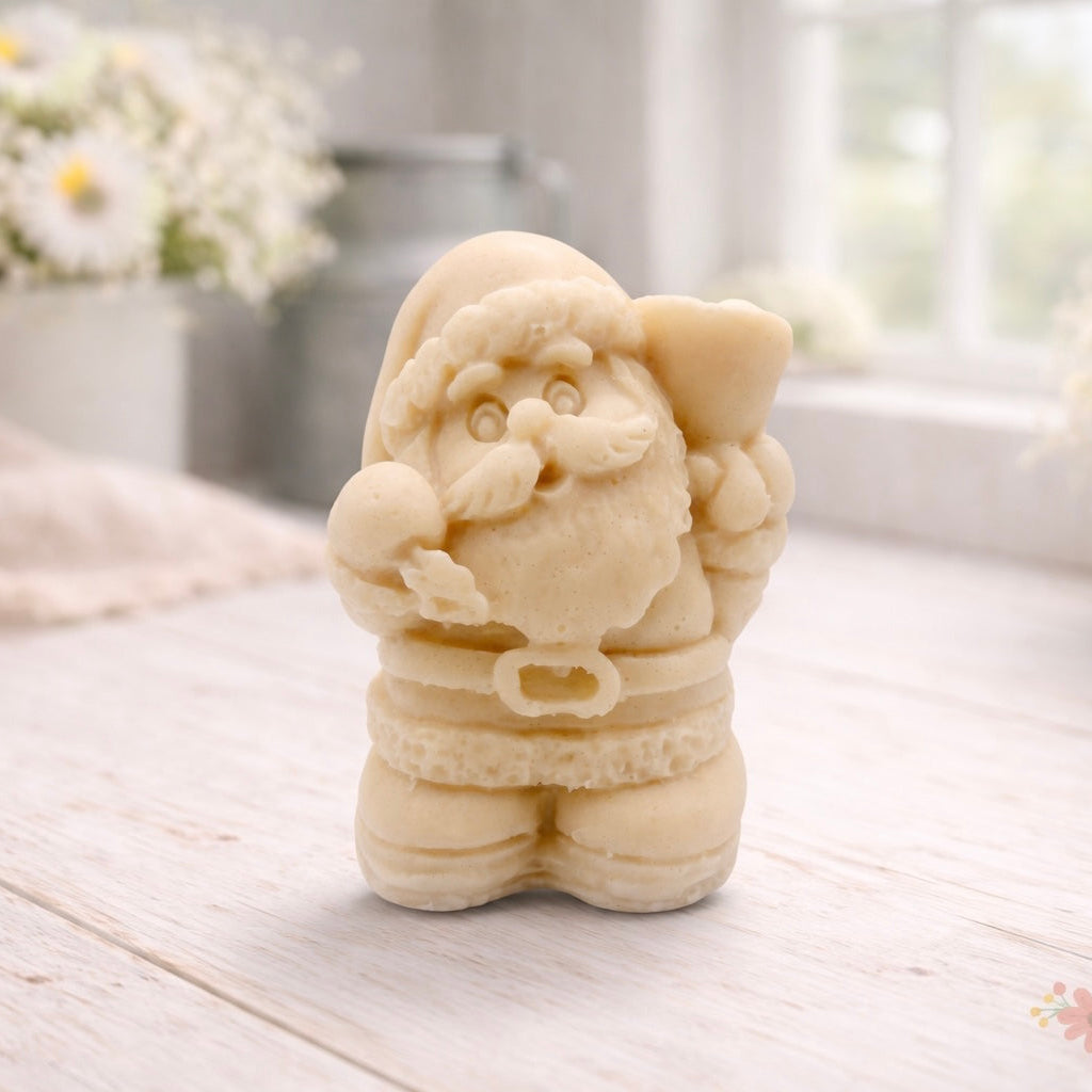A highly detailed 3D handmade vegan soap featuring a Father Christmas carrying a large sack of gifts over his shoulder and holding a bell, featuring an intricate curly beard and fur-trimmed suit, set against a festive holiday background.