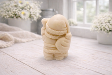 Load image into Gallery viewer, A highly detailed 3D handmade vegan soap featuring a Father Christmas carrying a large sack of gifts over his shoulder and holding a bell, featuring an intricate curly beard and fur-trimmed suit, set against a festive holiday background.
