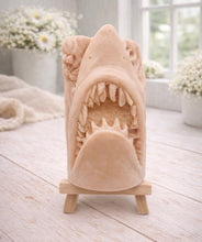 Load image into Gallery viewer, A 3D handmade vegan soap sculpted into a realistic great white shark head with its jaws wide open to reveal multiple rows of sharp teeth, displayed on a miniature wooden easel in a bright farmhouse setting.
