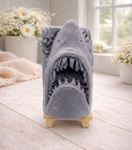 Load image into Gallery viewer, A 3D handmade vegan soap sculpted into a realistic great white shark head with its jaws wide open to reveal multiple rows of sharp teeth, displayed on a miniature wooden easel in a bright farmhouse setting.
