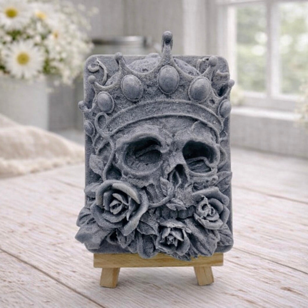 handmade vegan soap gift featuring a detailed relief of a skull wearing a crown, surrounded by a border of roses, displayed on a small wooden easel.