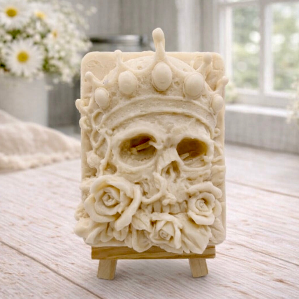 handmade vegan soap gift featuring a detailed relief of a skull wearing a crown, surrounded by a border of roses, displayed on a small wooden easel.
