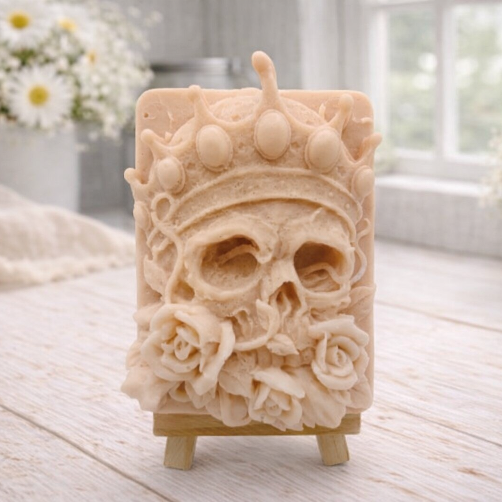 handmade vegan soap gift featuring a detailed relief of a skull wearing a crown, surrounded by a border of roses, displayed on a small wooden easel.