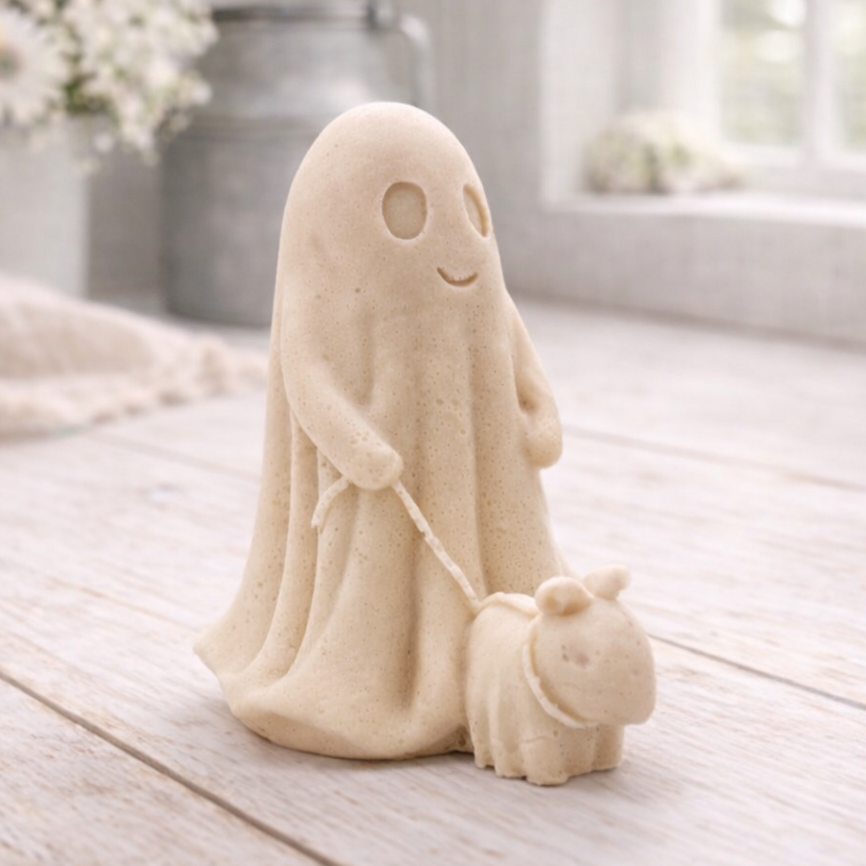 Decorative vegan soap figure of a ghost with a dog on a leash in a bright room with flowers.