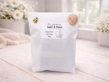 Load image into Gallery viewer, White product packaging with branding on a light wooden surface
