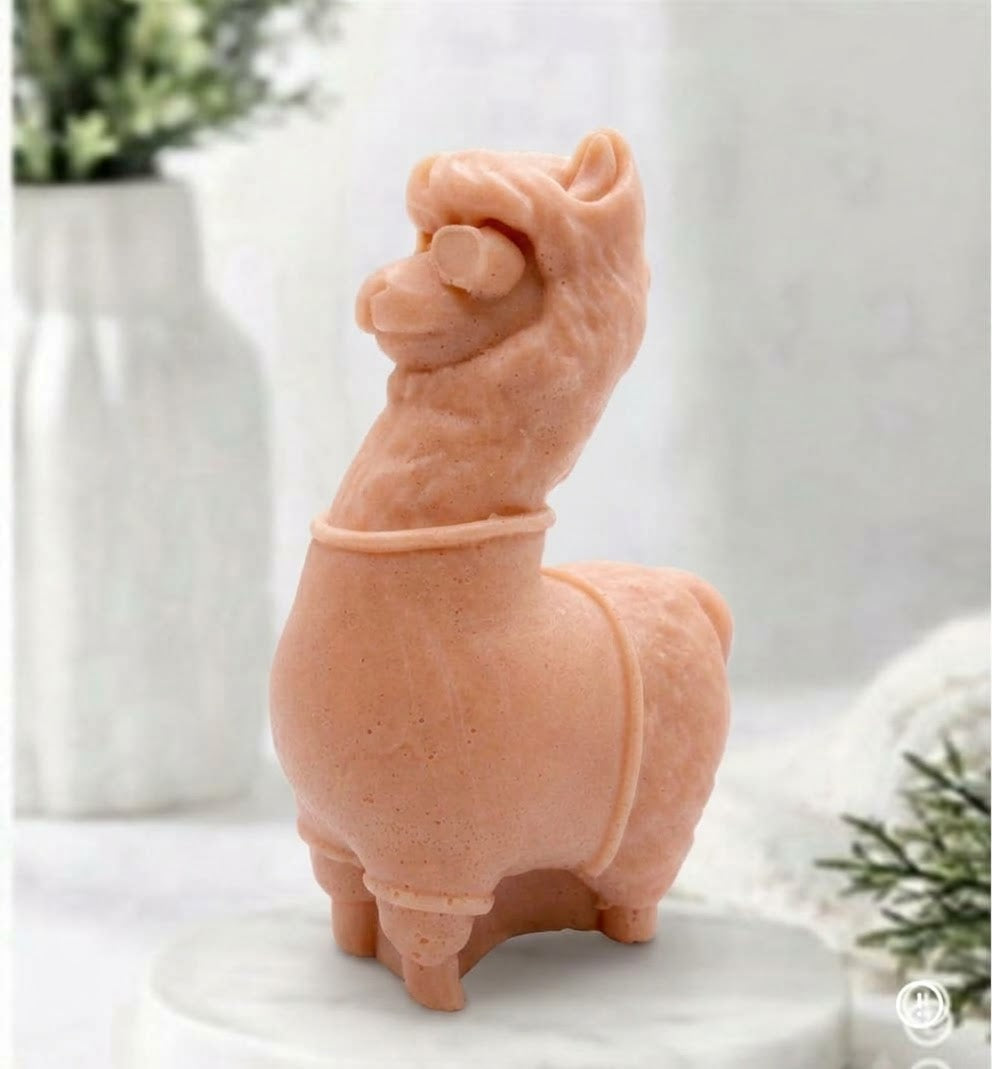 A terracotta coloured decorative llama / alpaca shaped vegan soap on a white surface.